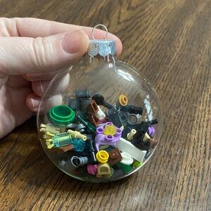 “5/$20” glass Christmas bulb with a variety of Lego pieces all sizes and colors